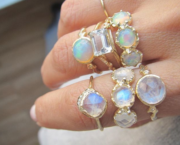 Set of moonstone rings on woman's hand.