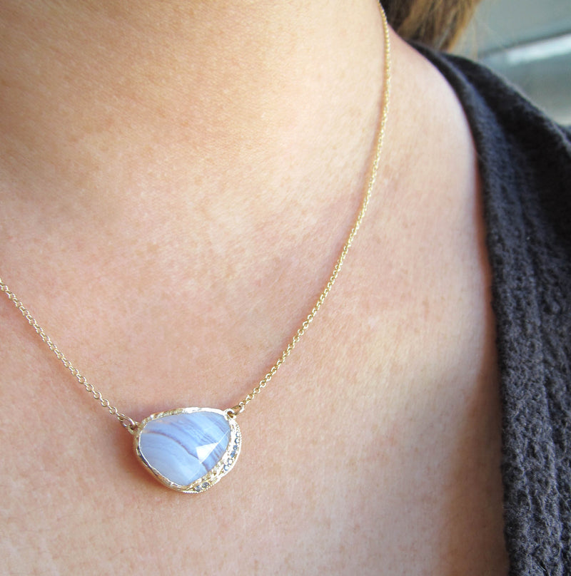 14k Blue lace agate hidden cove necklace with a strip of round brilliant sapphires.
