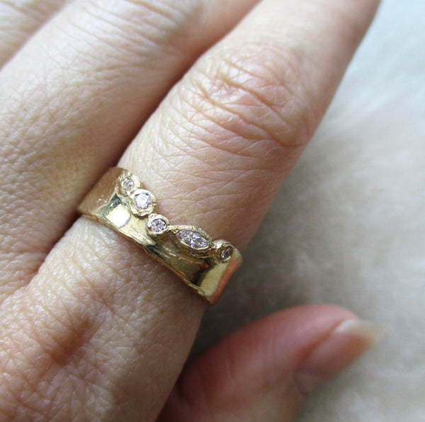Passage diamond ring with white round diamonds on hand.