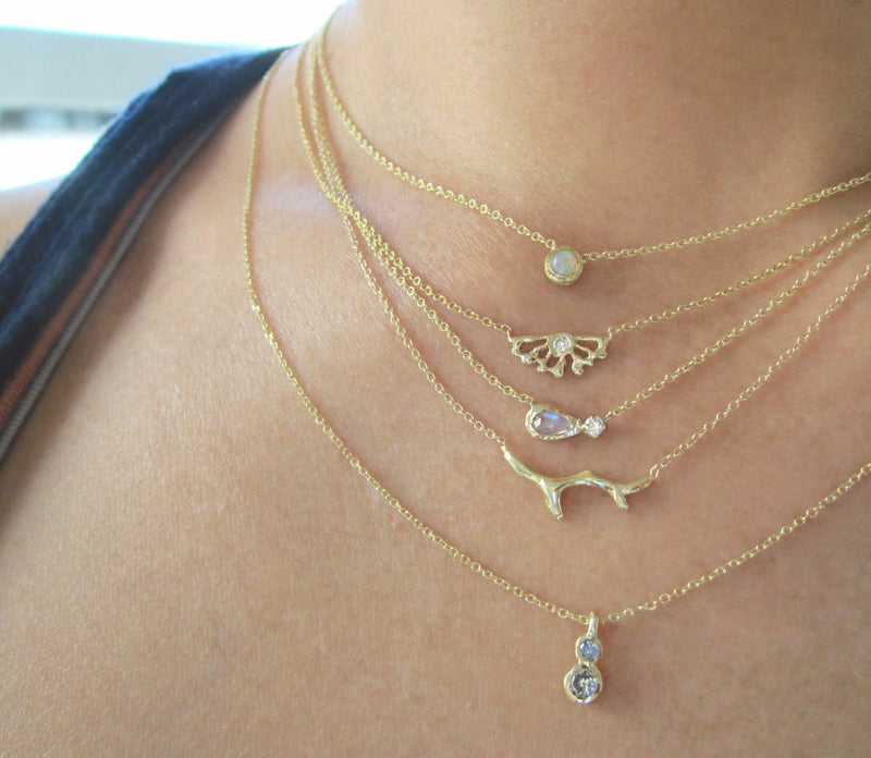 Twin Star Necklace with Grey Round Brilliant Diamonds with more Gold Necklaces on Woman''s Neck.
