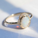 Oasis Opal Ring with White Round Brilliant Diamonds on Woman's Hand.