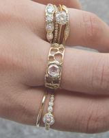 Gold ring with diamonds on woman's hand.