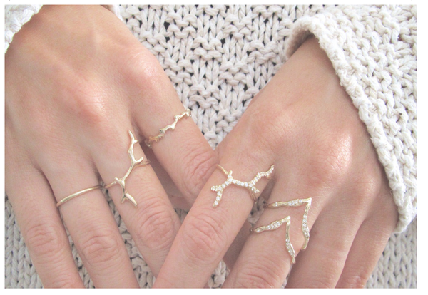 Handcrafted yellow gold rings on model's hand 