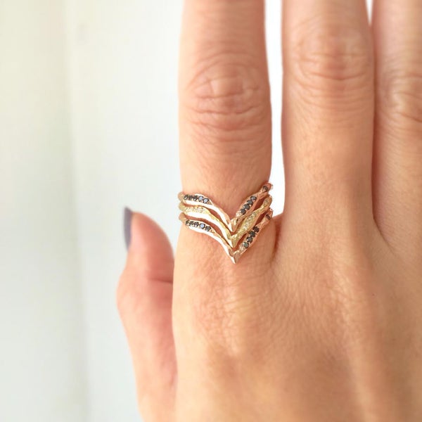 Yellow gold black diamond handcrafted rings on model's hand