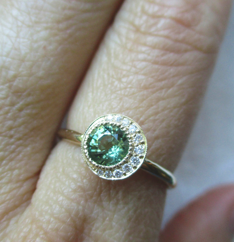 Handcrafted 14K yellow gold green sapphire ring on the hand