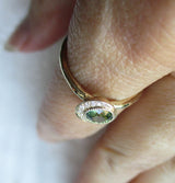 Handcrafted 14K yellow gold green sapphire ring on the hand side view