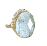 14K yellow gold aquamarine ring with white diamonds on white background 