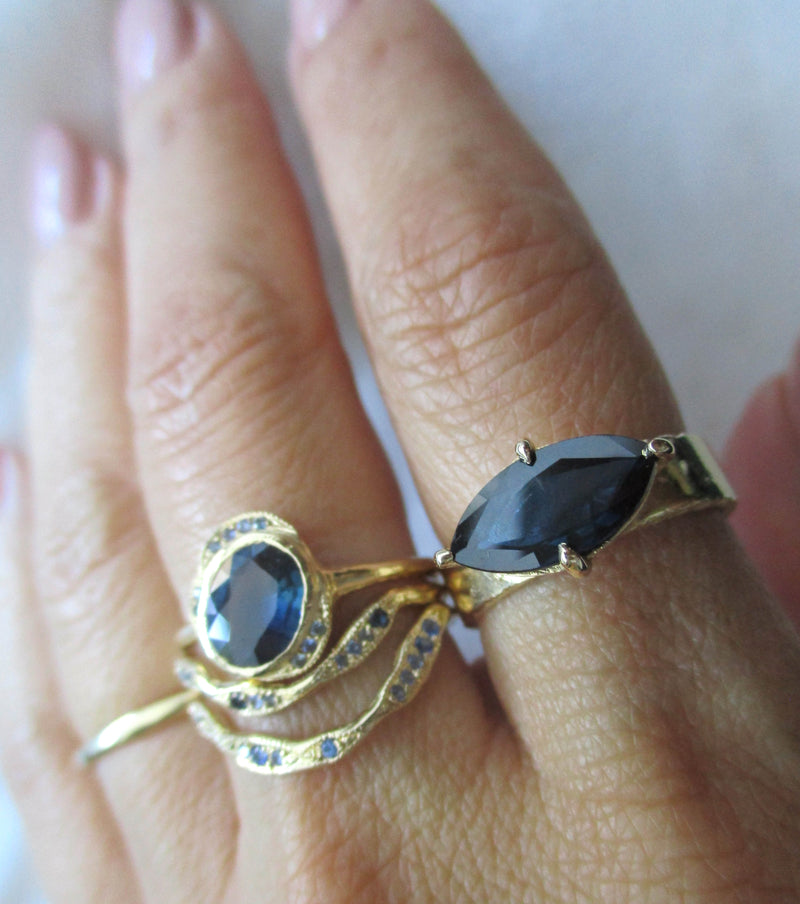 14K gold rings with blue sapphire gemstones on hand 