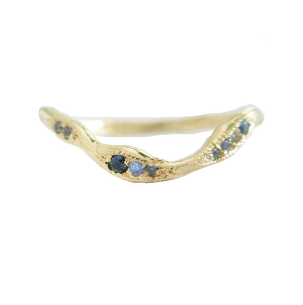 Gold ring with embedded blue gemstones on a white background