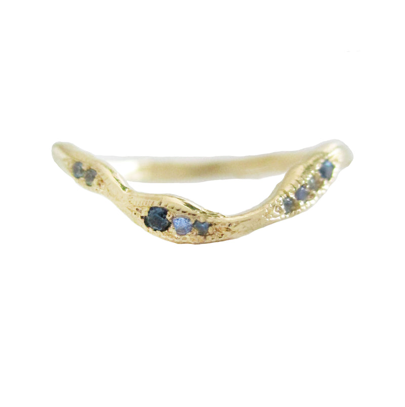 Gold ring with embedded blue gemstones on a white background