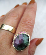 14K yellow gold ring with large ruby zoisite and rubies and gold wide band on the hand. 