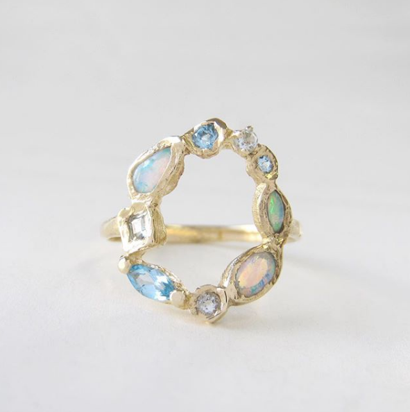Ama harbor mermaid ring made with opal, blue topaz and aquamarine front view.