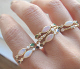 5 Aurora Emerald Rings on woman's hand. 