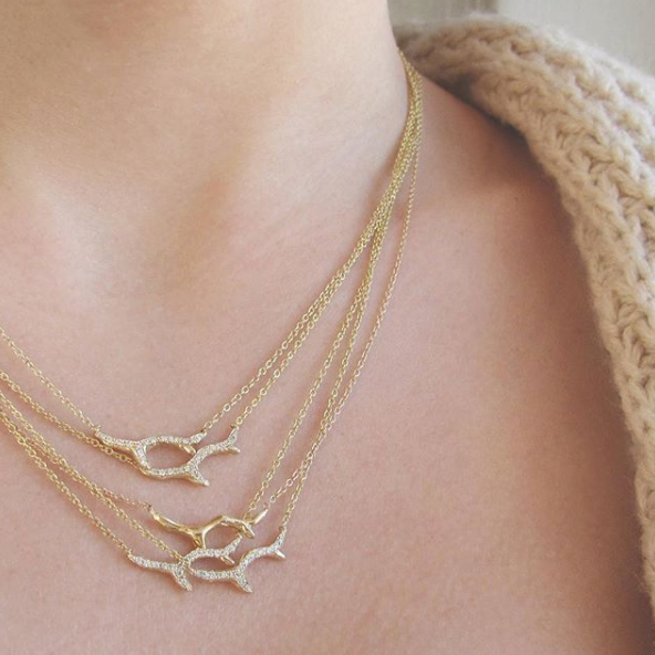 5 14k Yellow gold Branch Necklaces on woman's neck.