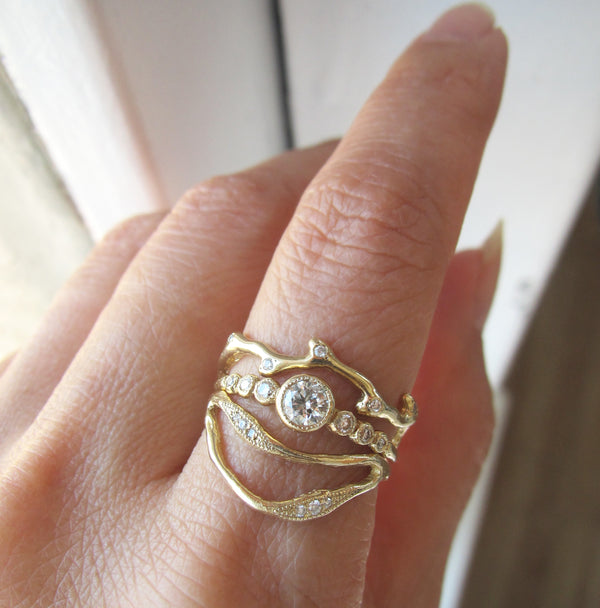 Double Tide Ring with White Round Brilliant Diamonds on Woman's Hand.