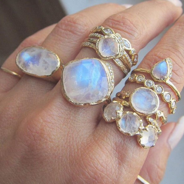Set of moonstone rings on woman's left hand.