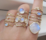 Moonstone rings on woman's hand.