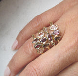 Rising phoenix ring made with morganite, pink tourmaline and smoky quartz on woman's hand.