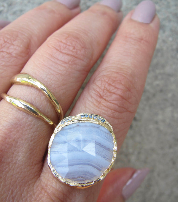 14K Gold blue lace agate hidden cove ring with a strip of blue round brilliant sapphires.