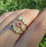 3 Floret opal ring with three white round brilliant accent diamonds.