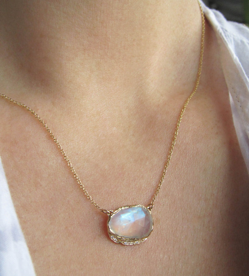 14K Gold blue moonstone hidden cove necklace with a strip of blue round brilliant sapphires.