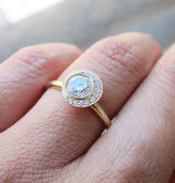 Crescent Diamond Ring with White Round Brilliant Diamond Center on Woman's Hand. 