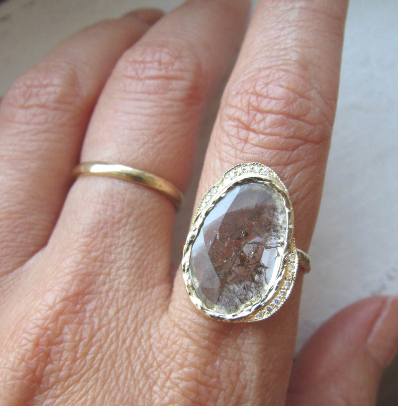 Diamond slice hidden cove ring with white round brilliant diamonds on Woman's Hand Top Angle.