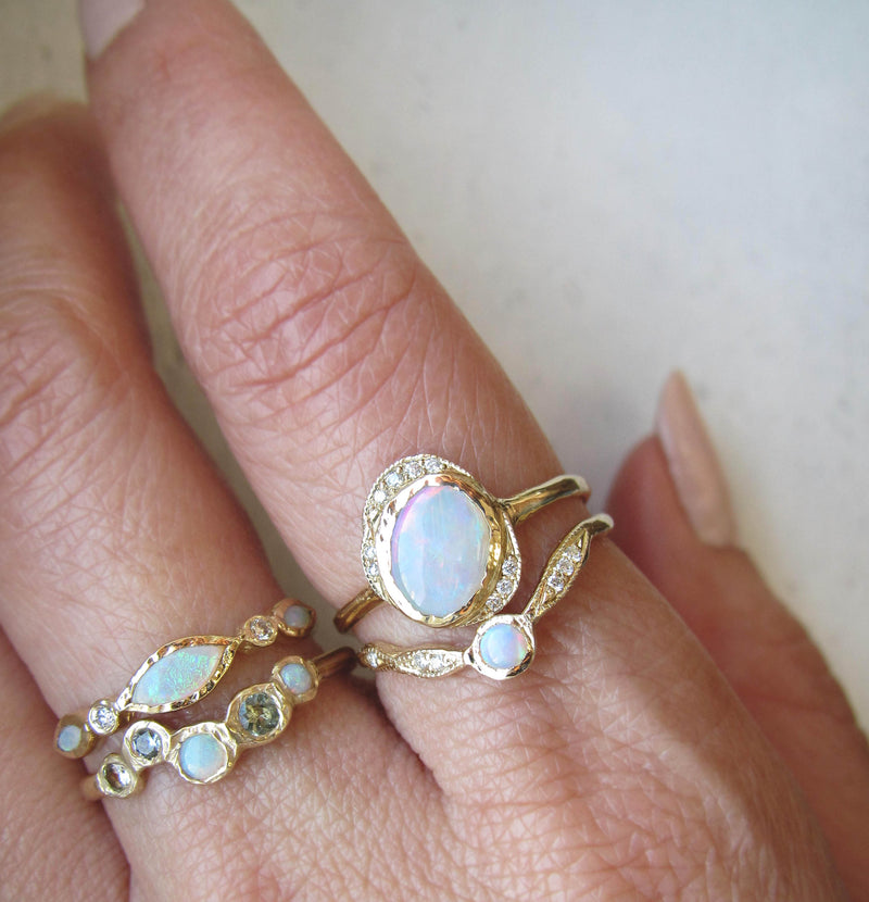 Lookout Point 3mm opal ring with white round brilliant diamonds on woman's hand. 