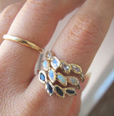 14K Yellow Gold Petal Opa Ring Next to Moonstone and Sapphire Rings. 