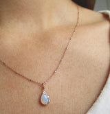 Single Raindrop Opal Necklace on woman's neck.