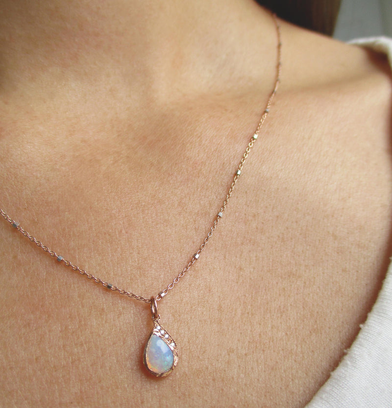 Single Raindrop Opal Necklace on woman's neck.