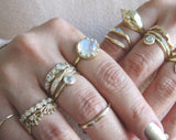 Set of yellow gold rings on woman's hand. 