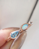 Marina mermaid ring with blue topaz, opal and aquamarine close-up.