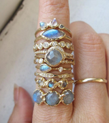 Labradorite rings collection on woman's hand.