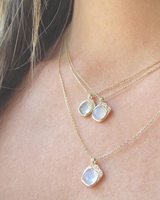 Three mini cove moonstone necklace with white round brilliant diamonds.