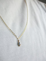 Bud Sapphire Necklace hanging of women's neck.