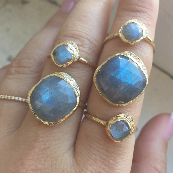 Mini and large cove rings on woman's hand. 