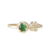 Floret emerald ring three white round brilliant accent diamonds.