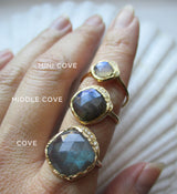 Mini cove, middle cove, cove gold rings on hand. 