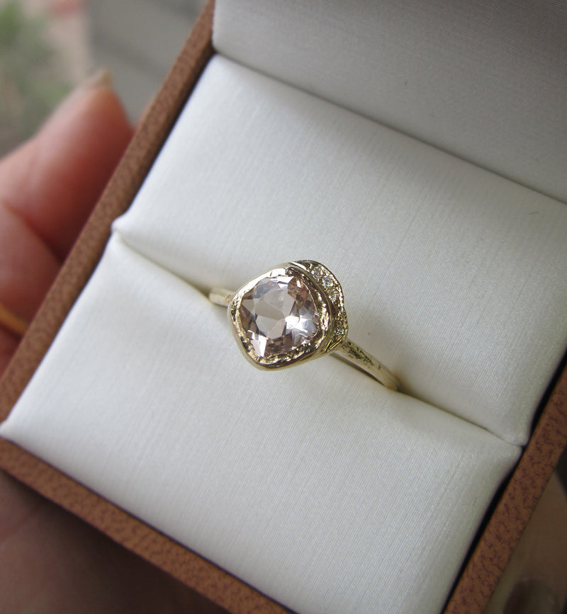Mini cove morganite ring with white round brilliant diamonds inside gift box.