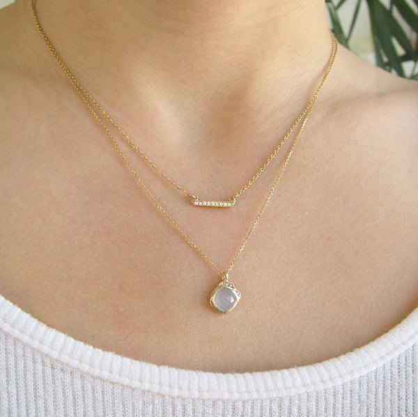 Mini cove chalcedony necklace with white round brilliant diamonds on woman's neck,