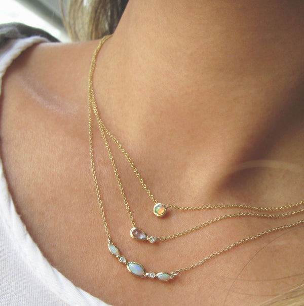 Guiding light necklace with white round brilliant diamonds on woman's neck.