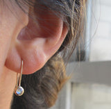 14K Superstar Earrings on woman's ear.