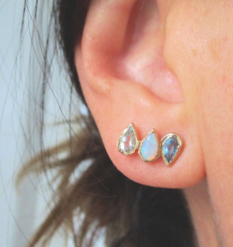 Rising Unicorn Earrings made with Aquamarine, opal and blue topaz on Woman's Ear.