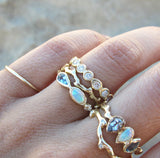 Marina mermaid ring with blue topaz, opal and aquamarine on woman's hand.