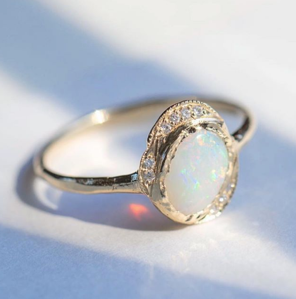 Oasis Opal Ring with White Round Brilliant Diamonds on Woman's Hand.