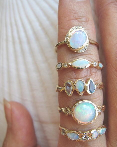 5 Opal and mermaid rings on woman's hand. 