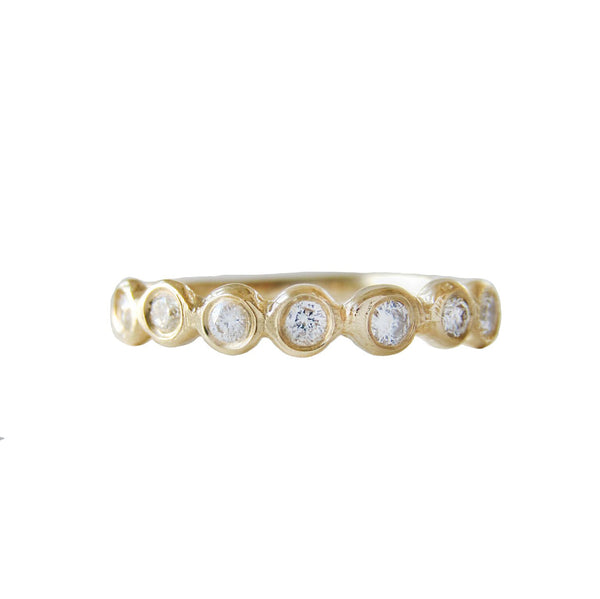 Tauri diamond ring with seven white round brilliant diamonds.