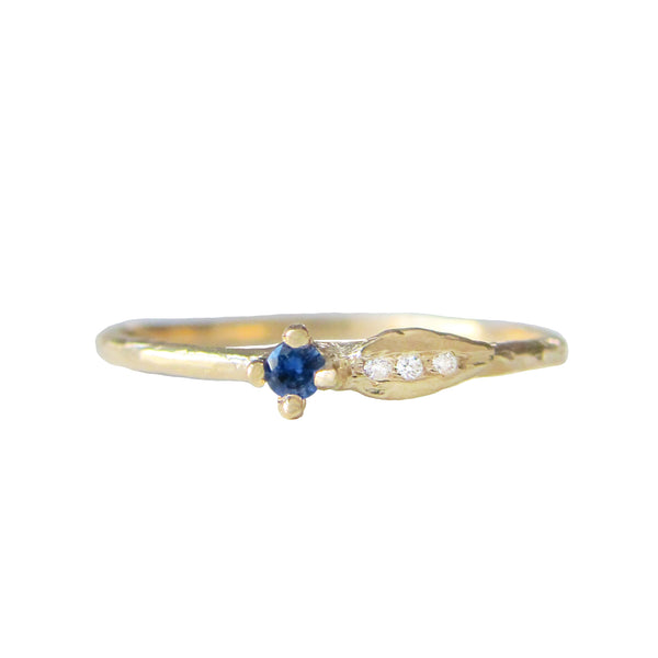 Sprout sapphire ring with three white round brilliant accent diamonds.
