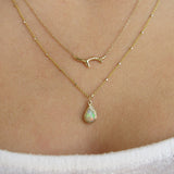 Raindrop Opal Necklace on woman's neck.